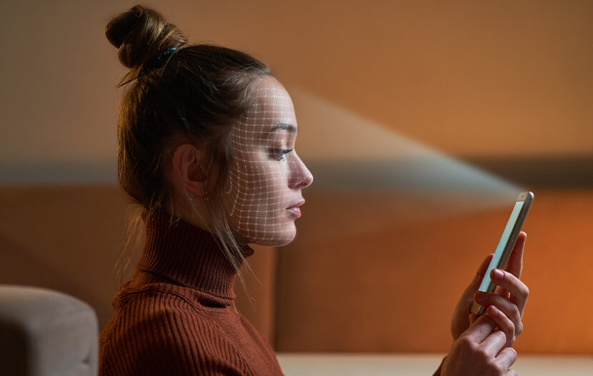 Woman scanning her face with phone