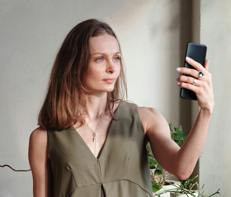 Woman taking a selfie for skin analysis